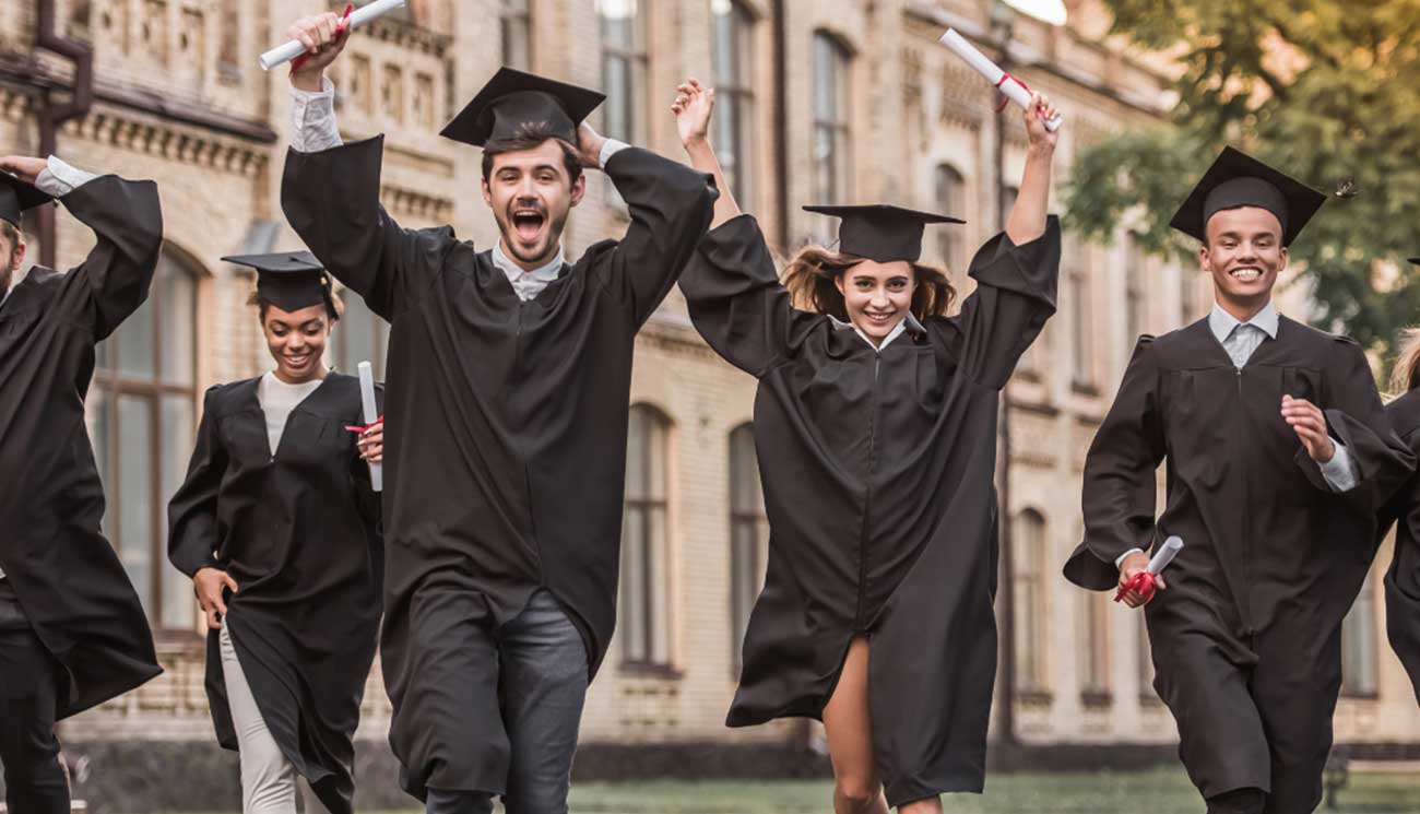 Some people are seen jumping and tossing their graduation hats.