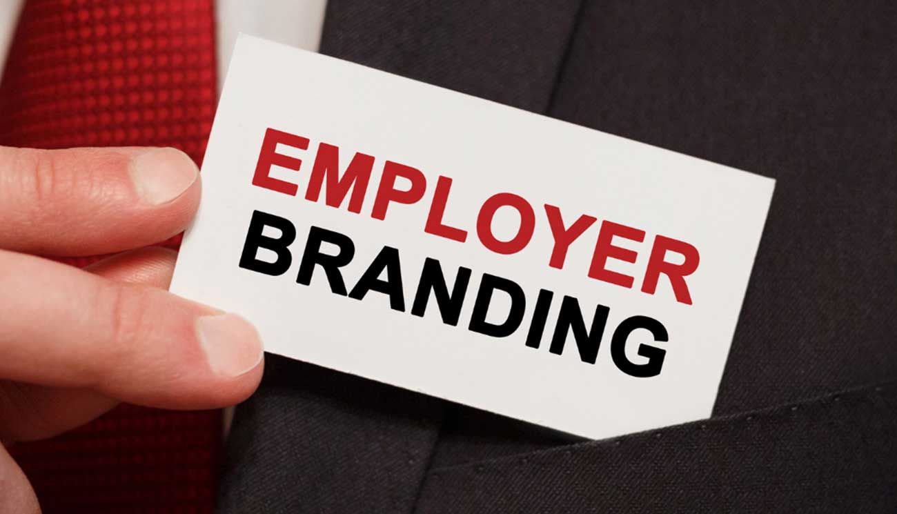 This photo shows a man pocketing a card with employer branding written on it