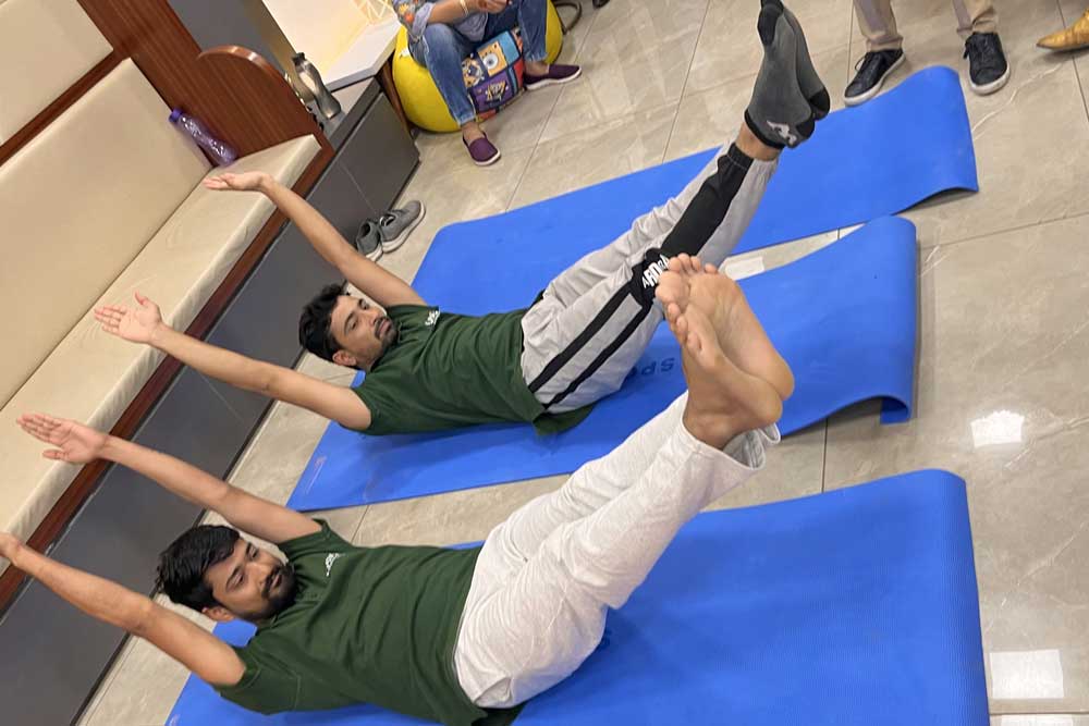 Two people are doing yoga on Yoga Day and celebrating this day.