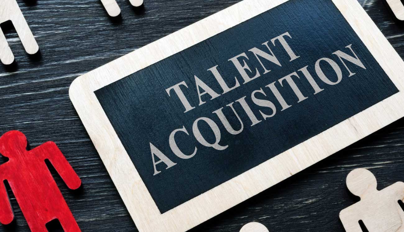 This picture shows a board with the word TALENT ACQUISITION written on it